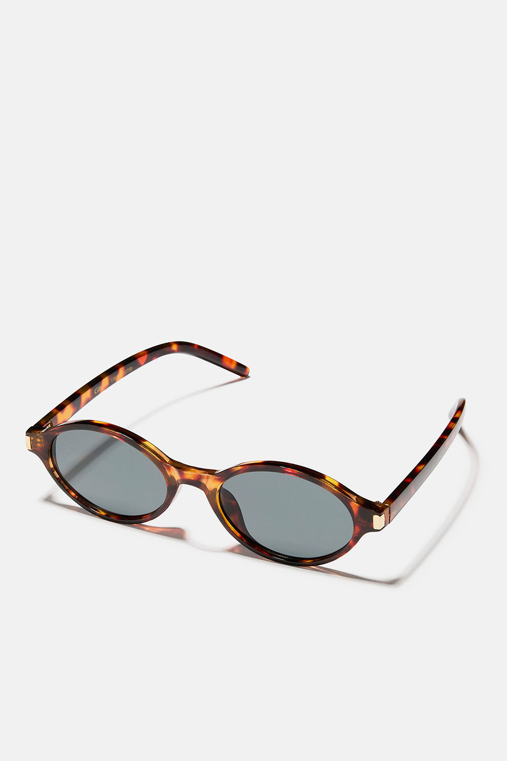 Ruskeat soikeat aurinkolasit, joissa kullanvärinen yksityiskohta