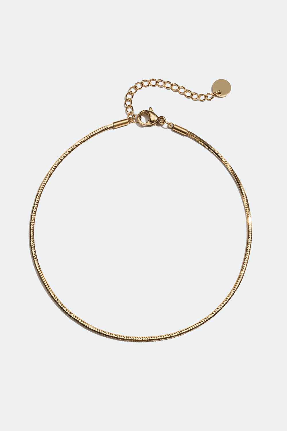 Teräksestä ja 18k kullasta valmistettu nilkkakoru, jossa pyöristetty käärmeketju