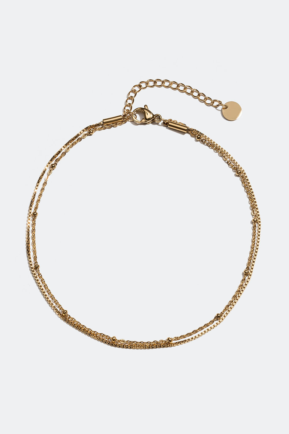 Teräksestä ja 18k kullasta valmistettu nilkkakoru, jossa kaksoislenkit