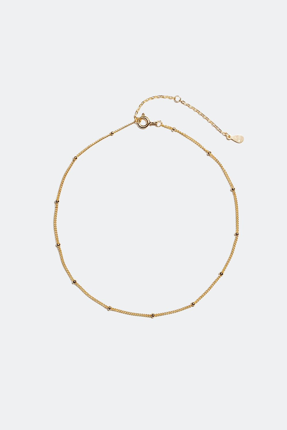 Nilkkakoru koristepalloilla, 18 karaatin kultaus